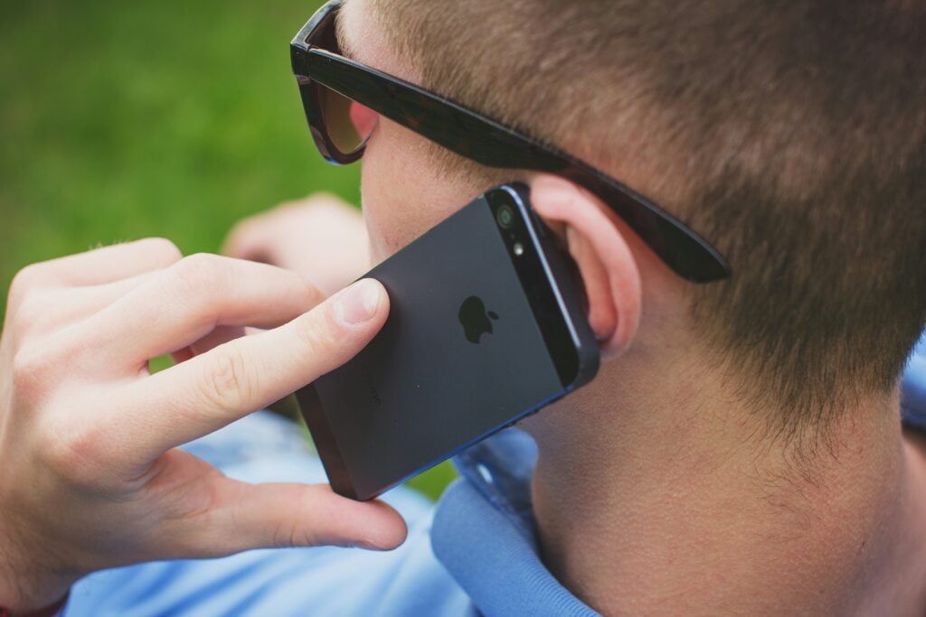 TCPA TCPA laws man holding phone telemarketing Telemarketer