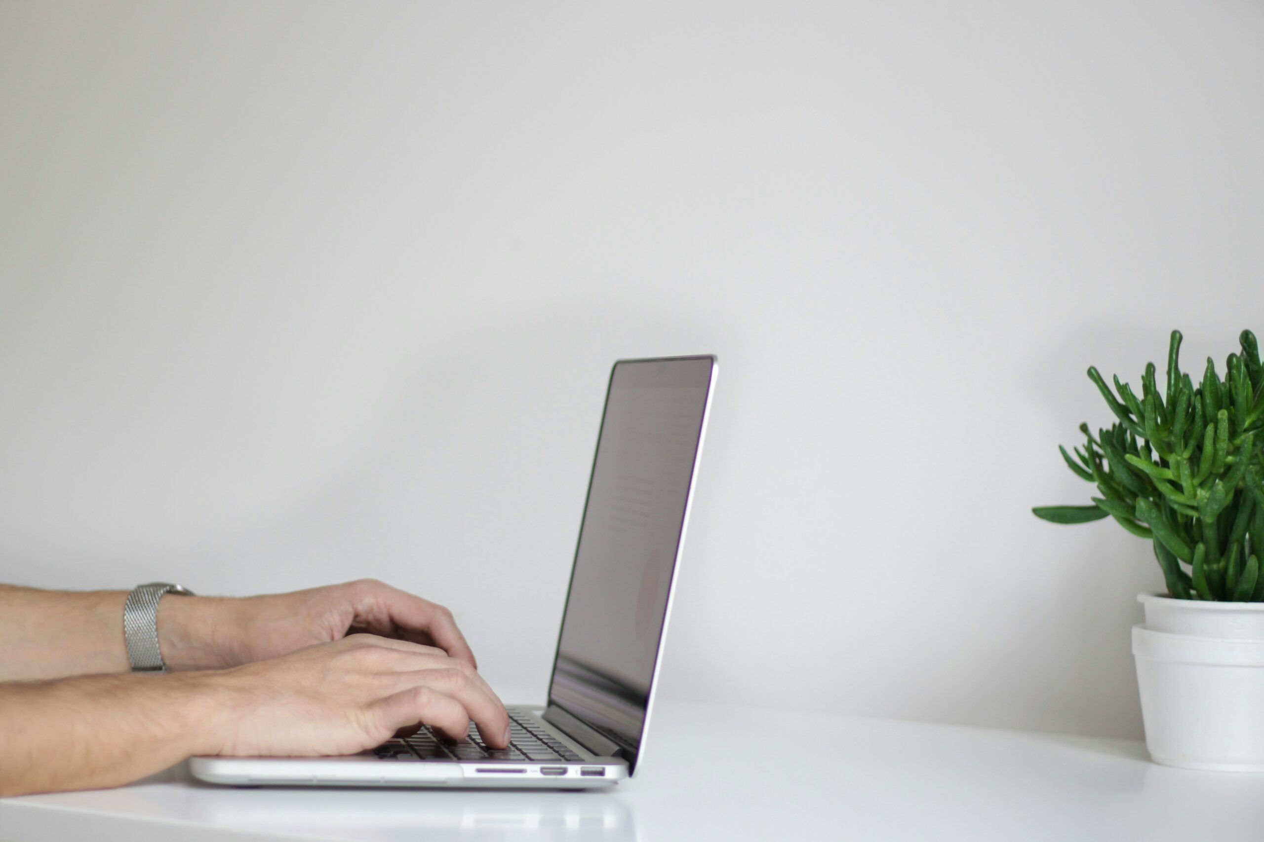 email wiretapping person typing at laptop urban outfitters