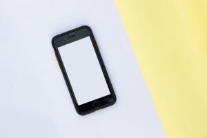 cell phone TCPA solicitation telemarketing attorney cell phone on table with yellow and white background