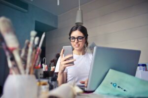 girl in art studio on the phone one to one TCPA telemarketing