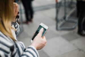 TCPA telemarketing tcpa laws woman holding phone outside