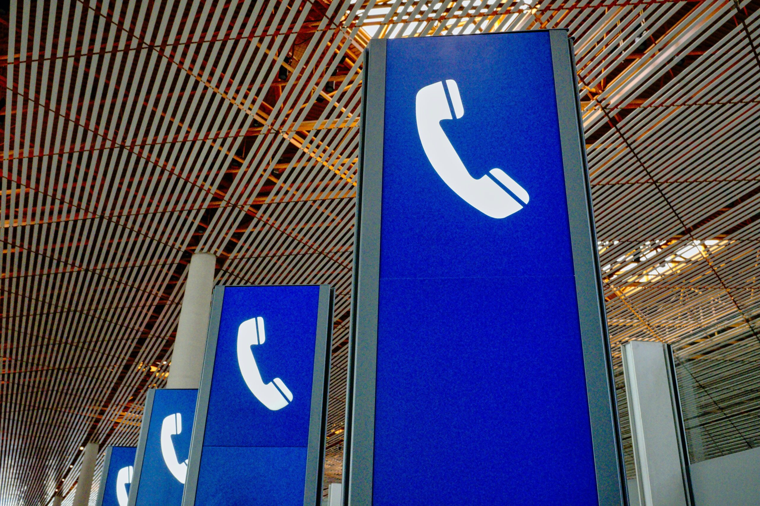 blue phones california wiretap CIPA blue signs with white phones on them in an airport telemarketing TCPA