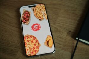 cell phone sitting on table with the pizza hut app open on it pizza TCPA complaint