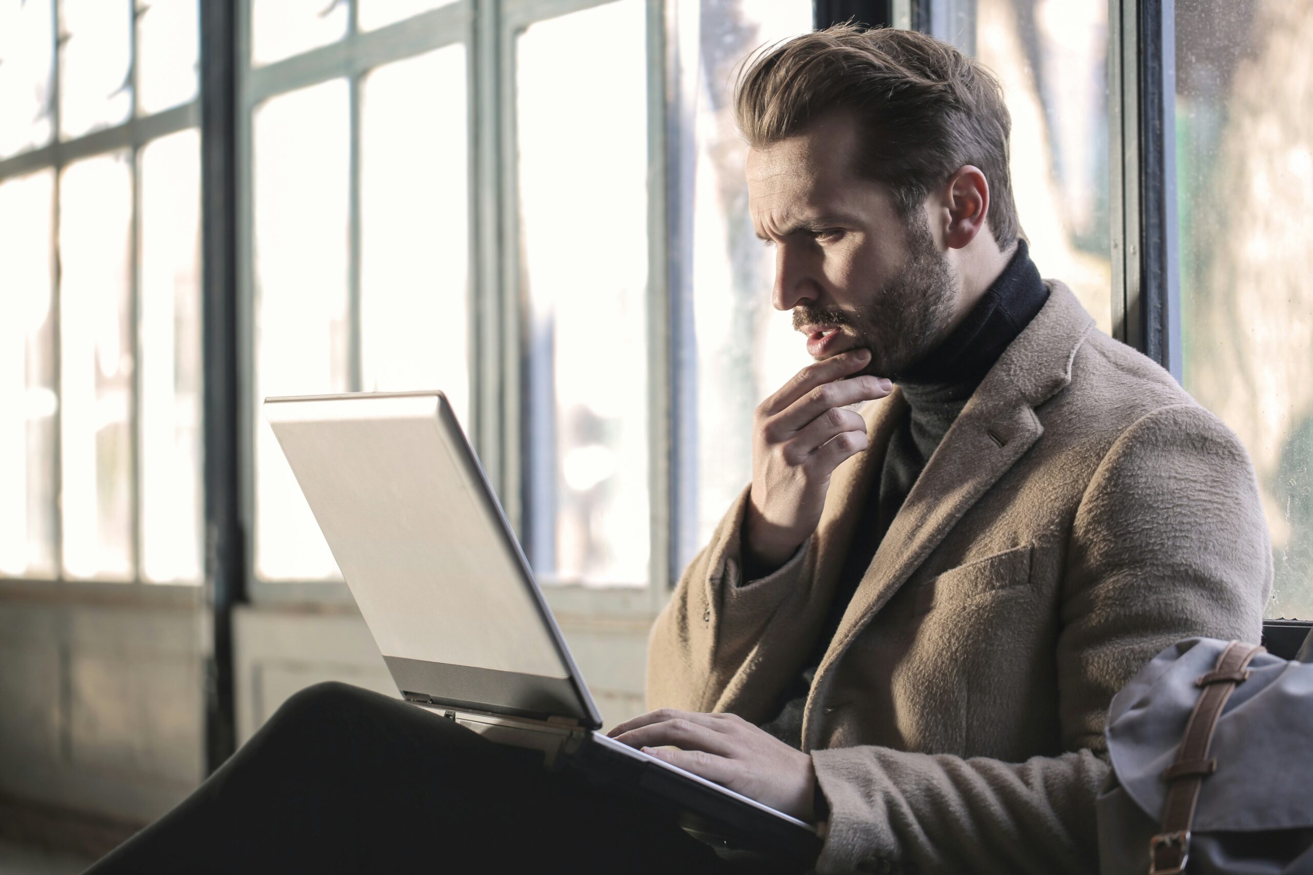 guy with beard looking confused at his laptop legal sweepstakes