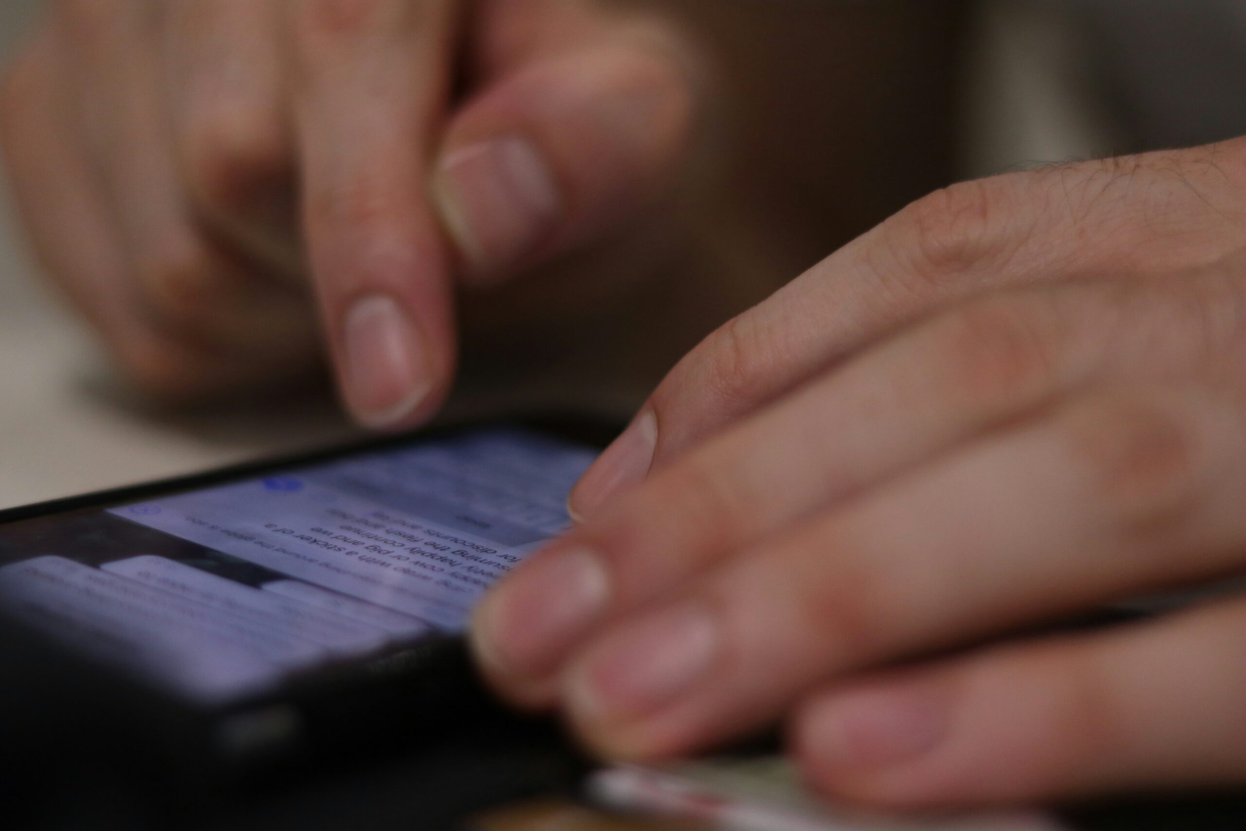 person texting on phone with text messages on screen you only see hands caller ID telemarketing tcpa law