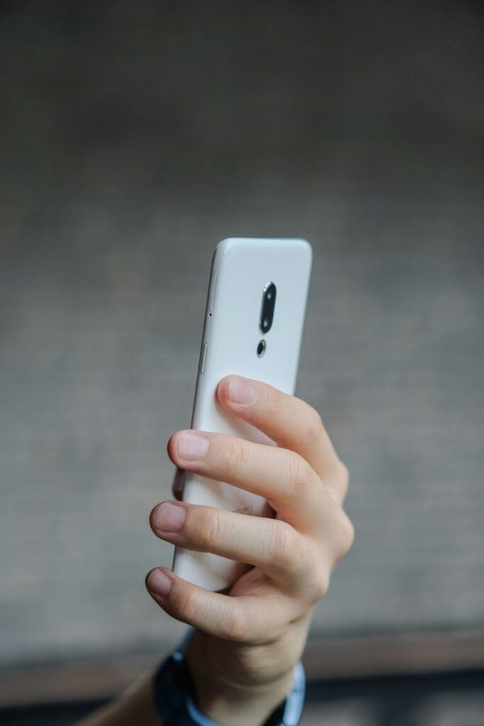 TCPA Rule man holding phone white phone