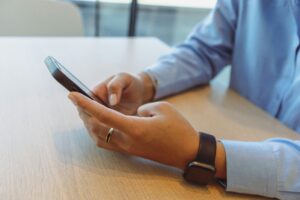 man on phone at desk with blue button down shirt daniels law lawsuit
