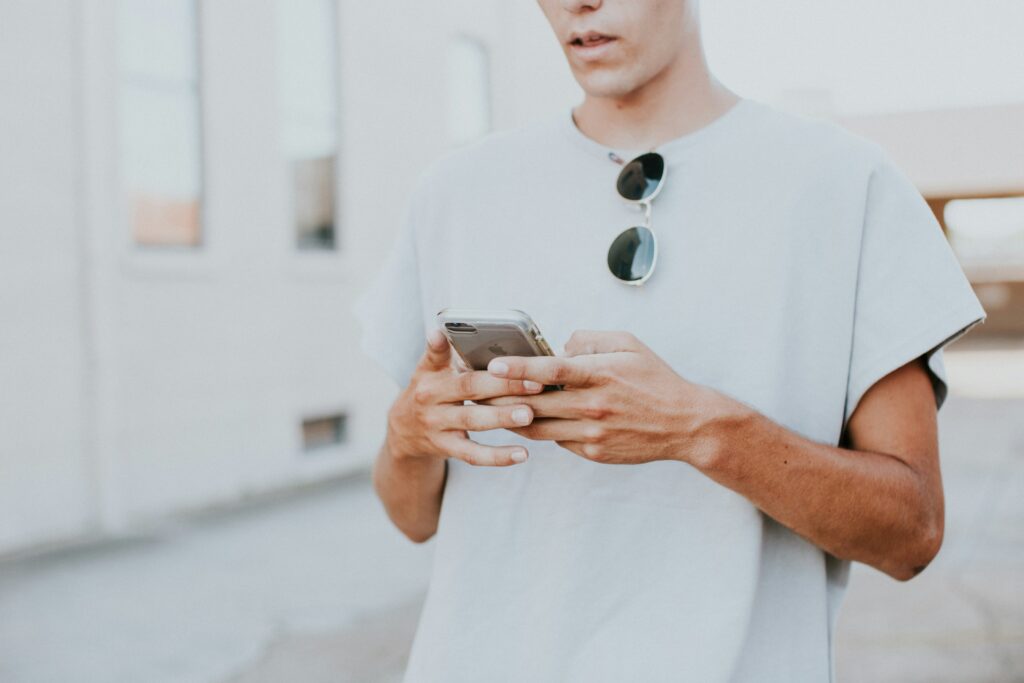 white guy texting in white tshirt long code tcpa telemarketing