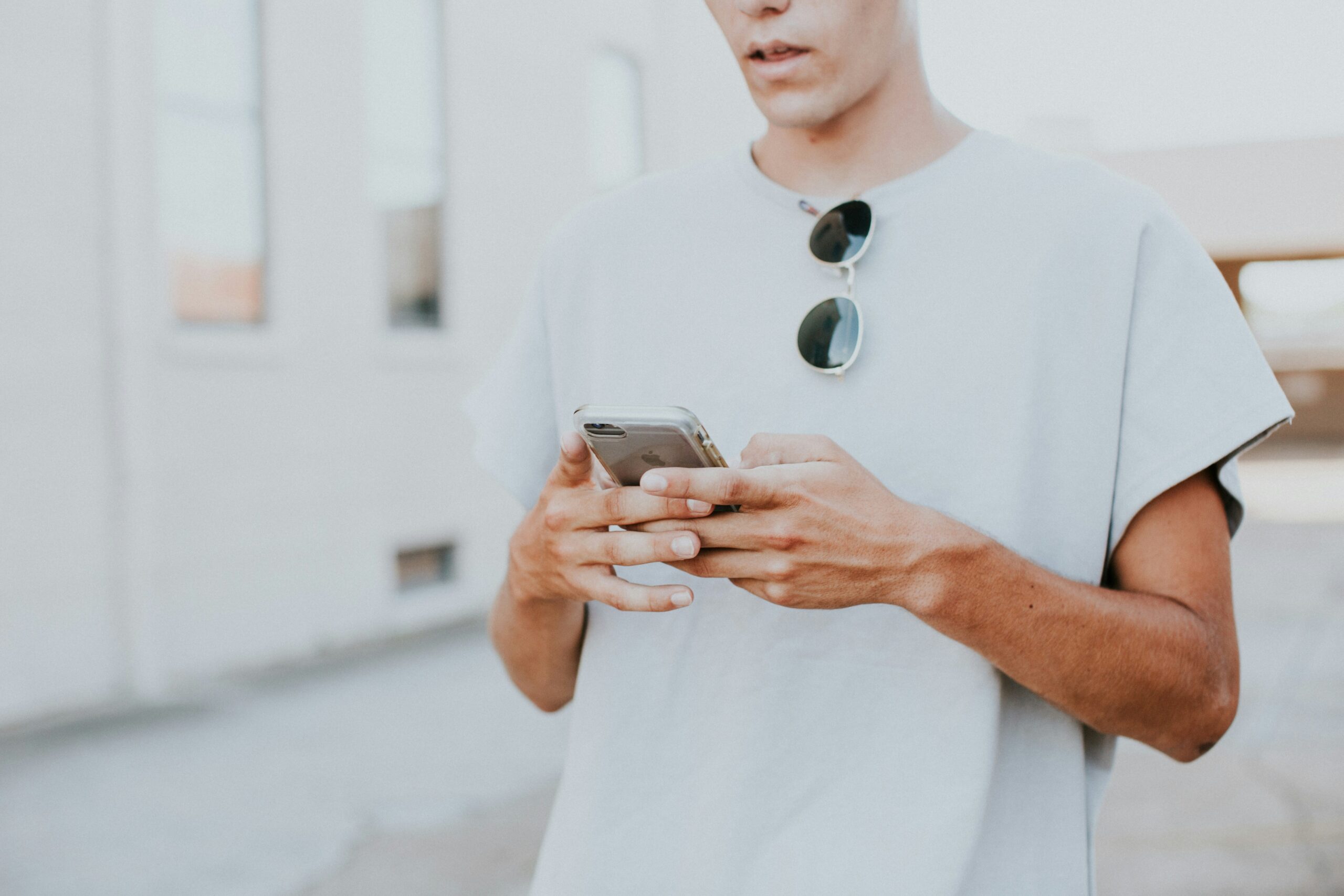 white guy texting in white tshirt long code tcpa telemarketing