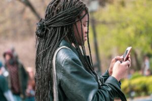 black girl on her iphone telemarketing consent telemarketers TCPA CCPA data and privacy law
