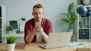 CIPA DEMANDS GUY WHO IS A REDHEAD LOOKING AT CELLPHONE AND LAPTOP