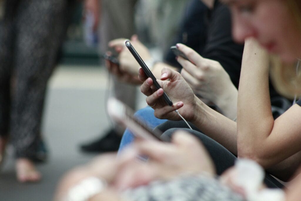people on their cell phone in a crowd CIPA laws
