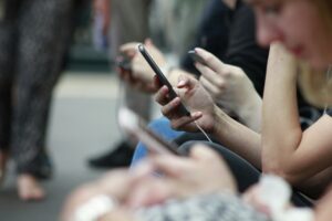 people on their cell phone in a crowd CIPA laws